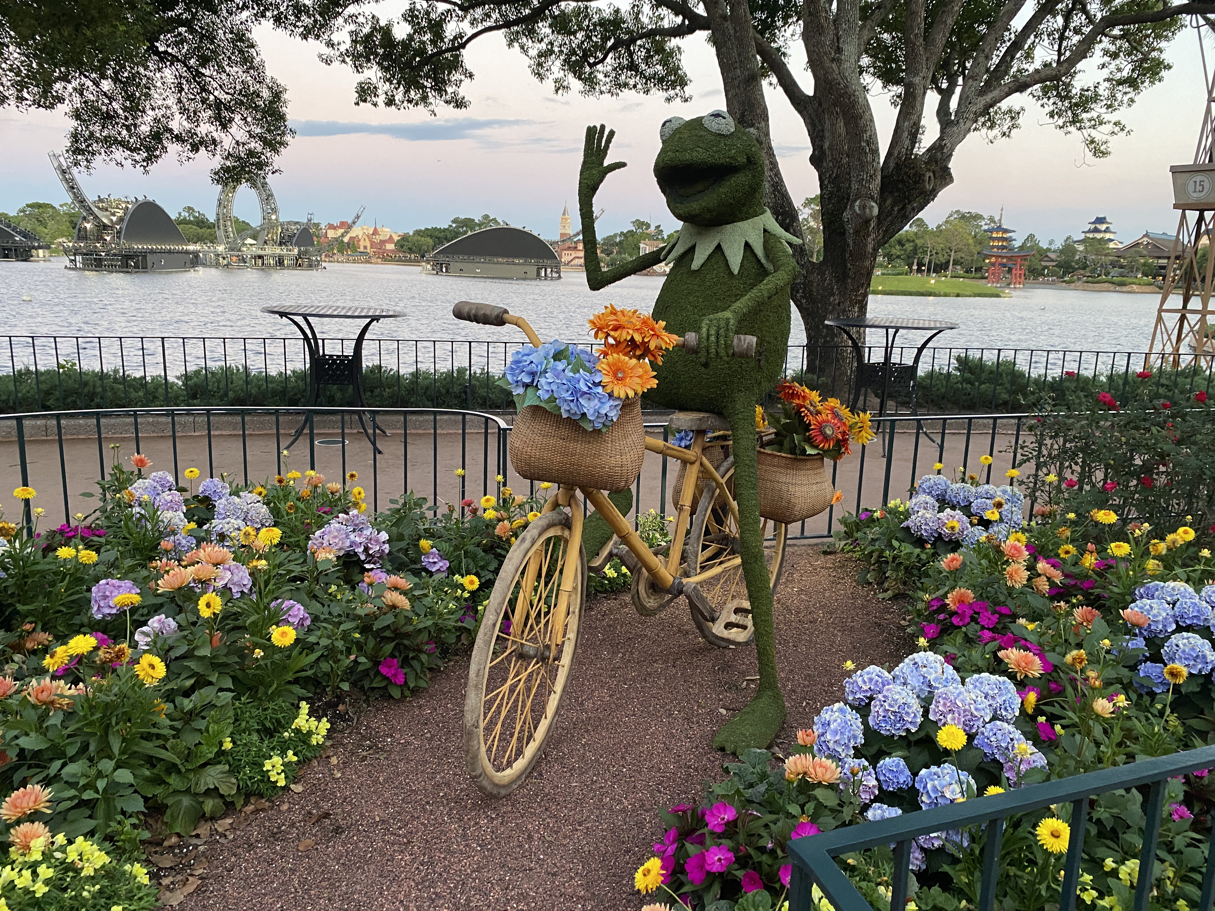 Dragonfly sculpture surrounded by colorful hydrangeas and marigolds at EPCOT Flower and Garden Festival.